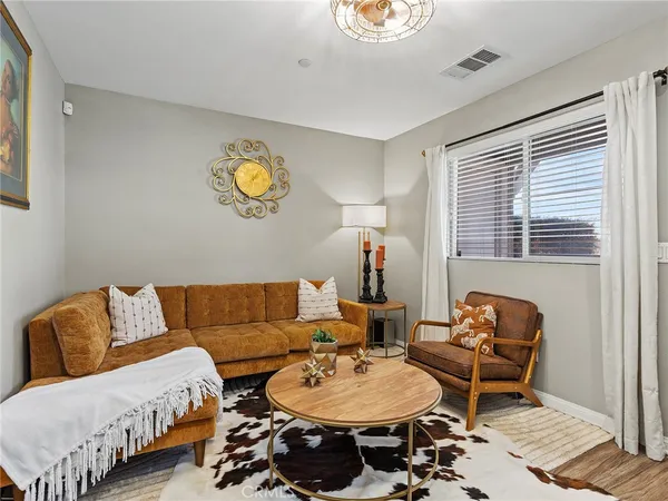 a living room with furniture a rug and a window