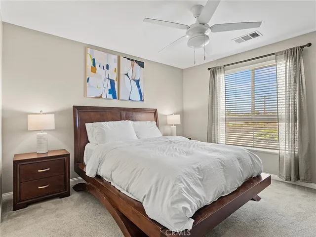 a bedroom with a bed and a painting on the wall