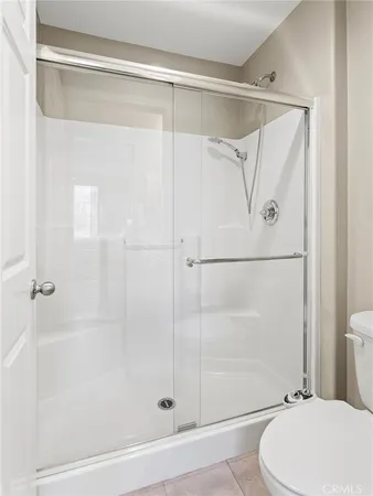 a bathroom with a glass shower door