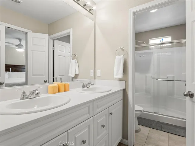a bathroom with a double vanity sink mirror double and shower