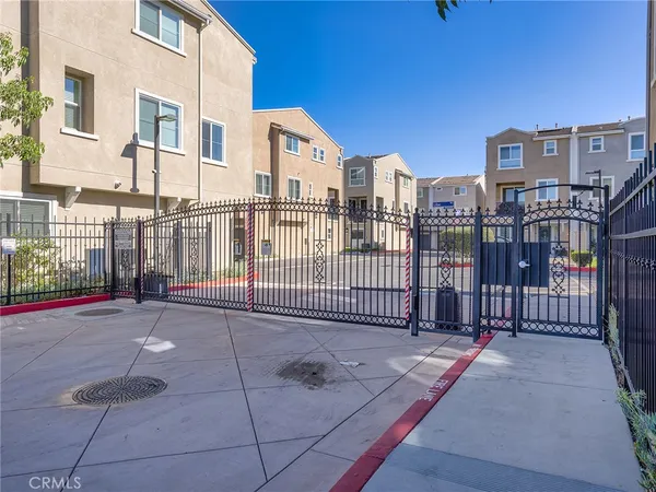 a view of a building with a bench in a backyard