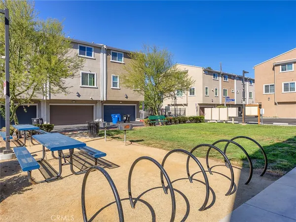 a view of a swimming pool with outdoor seating and barbeque oven