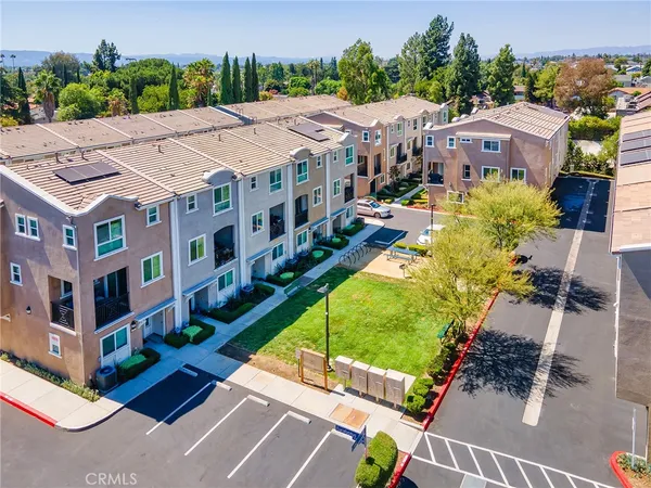an aerial view of multiple houses with a yard