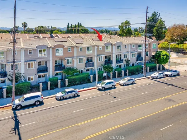 a view of a street with a cars parked in front of it