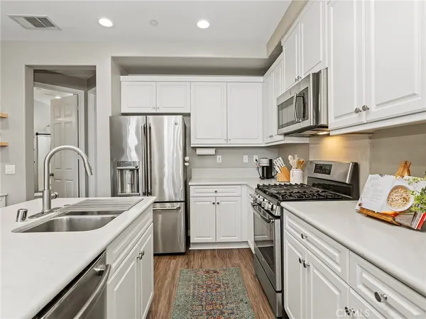 a kitchen with a sink stove and refrigerator