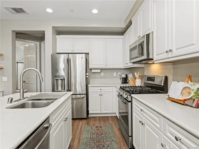 a kitchen with a sink stove and refrigerator