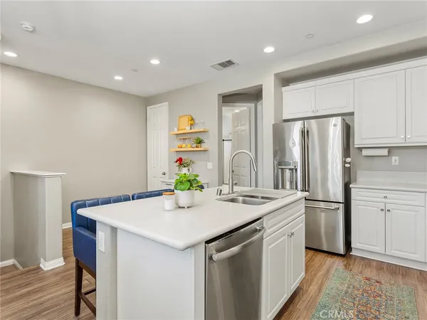 a kitchen that has a sink cabinets counter space and stainless steel appliances