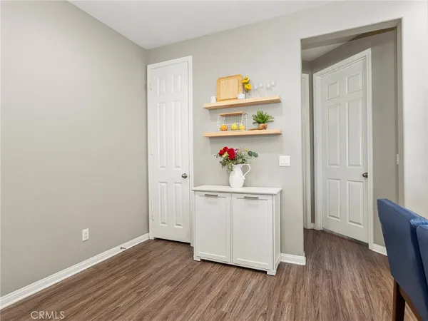 a utility room with wooden floor washer and dryer