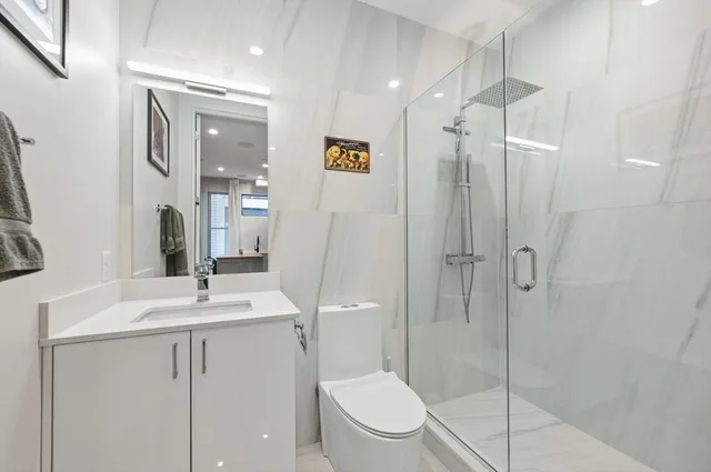 a bathroom with a toilet a sink and shower