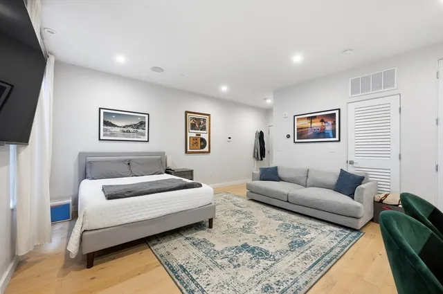 a bedroom with a bed and couch