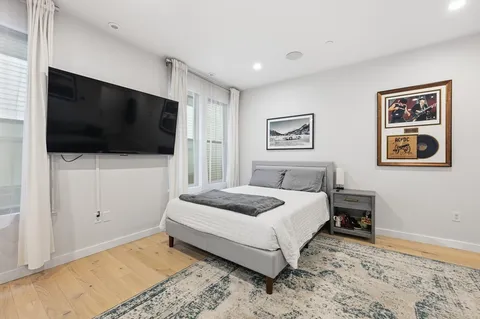 a bedroom with a bed and a flat screen tv