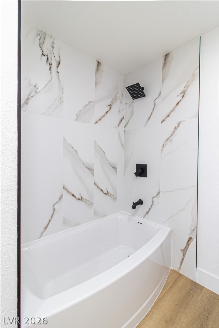 1891 Brian Road Pahrump, NV 89048 - Photo 23 of 50 Bathroom featuring shower / washtub combination and wood finished floors