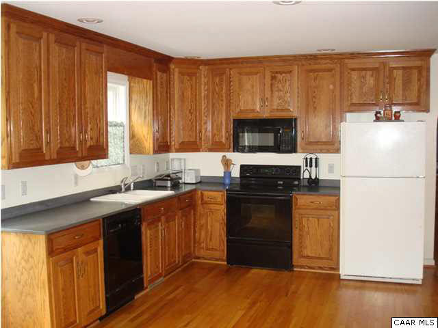 244 Starcrest Road Charlottesville, VA 22902 - Photo 4 of 17 a kitchen with a stove a sink and a microwave
