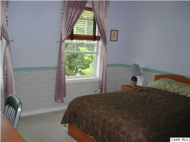 244 Starcrest Road Charlottesville, VA 22902 - Photo 6 of 17 a bed sitting in a bedroom next to a window