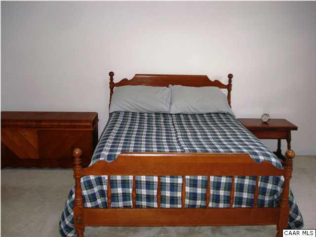 244 Starcrest Road Charlottesville, VA 22902 - Photo 7 of 17 a bedroom with a bed and wooden floor