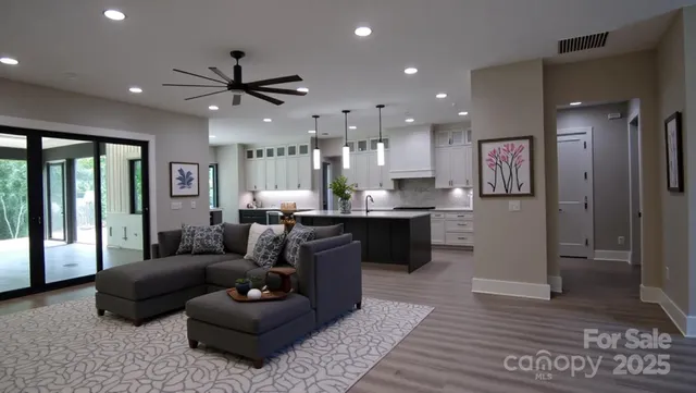 a living room with furniture and a wooden floor