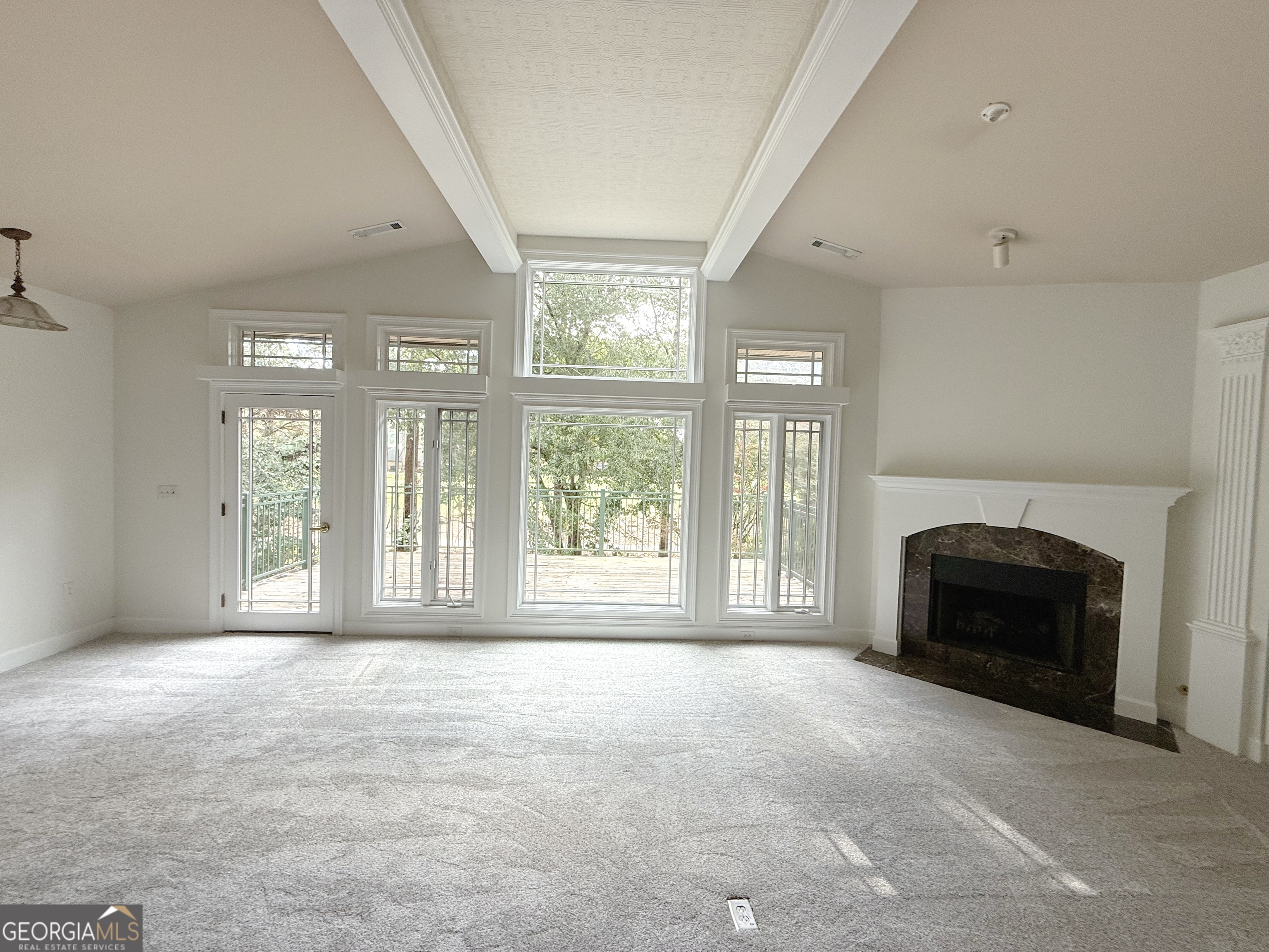 1235 Robinson Road Peachtree City, GA 30269 - Photo 2 of 9 a view of a livingroom with a fireplace and large windows