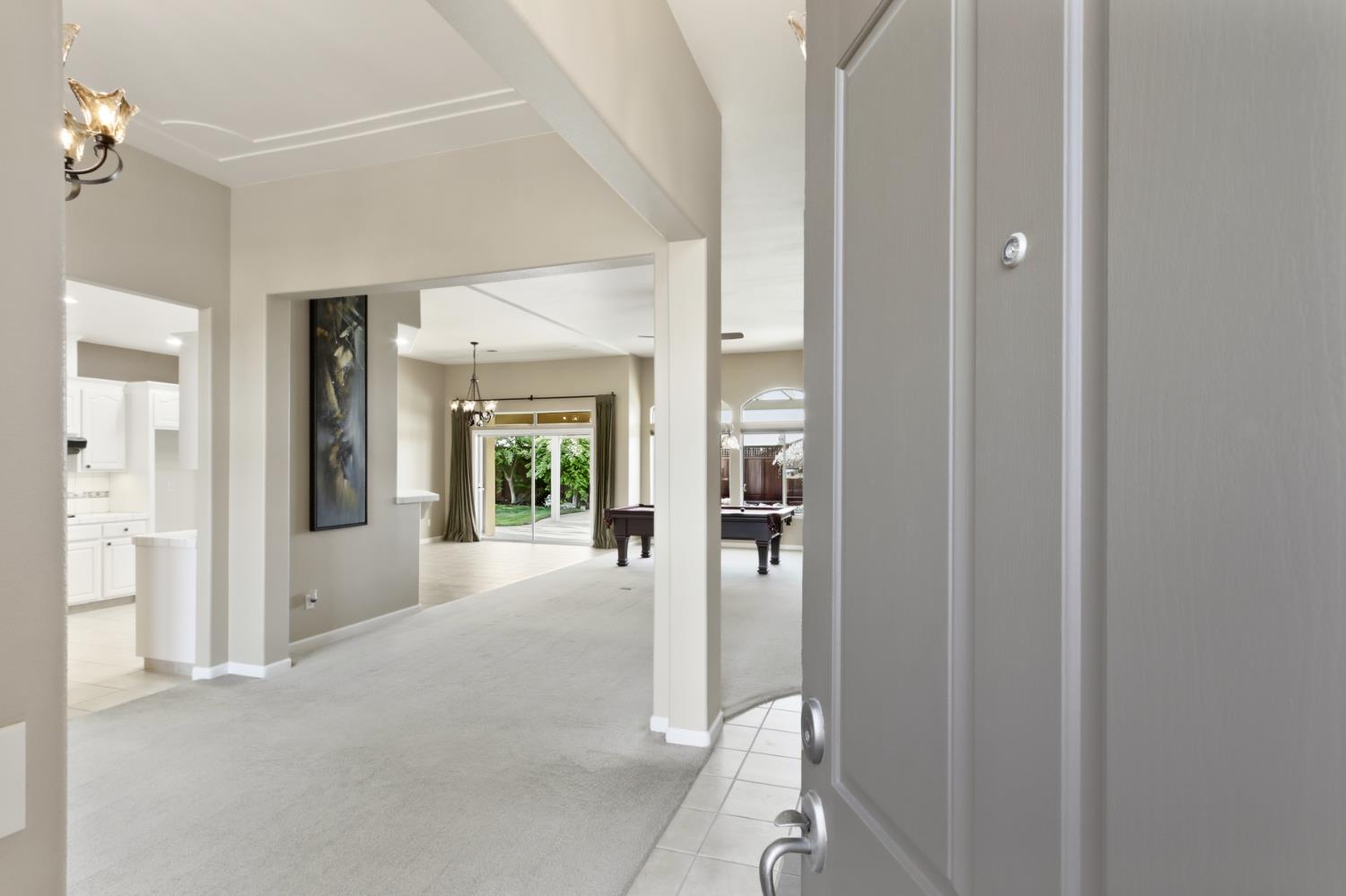 702 Shakeley Lane Ione, CA 95640 - Photo 11 of 71 a view of a hallway with wooden floor and a living room