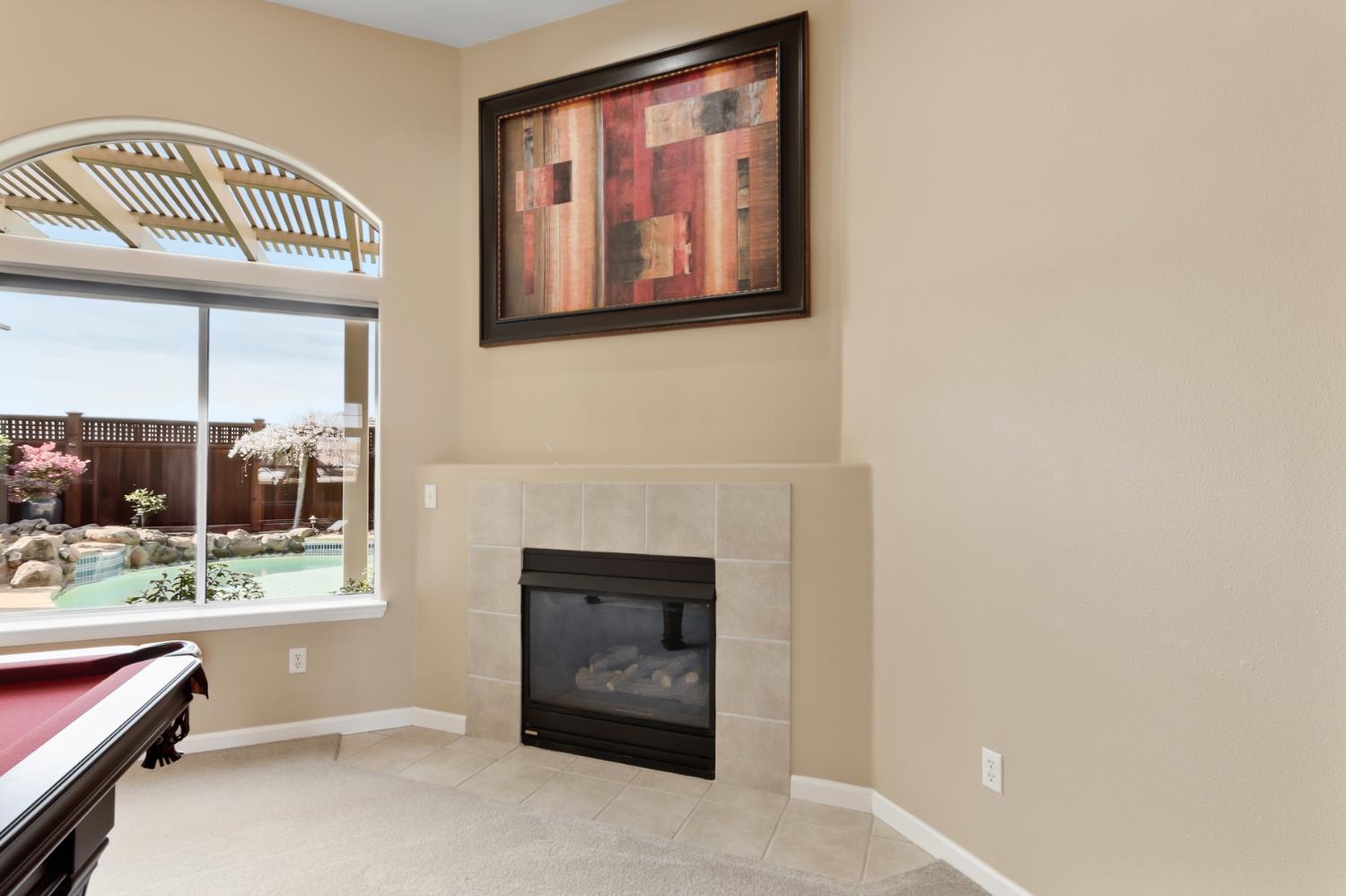 702 Shakeley Lane Ione, CA 95640 - Photo 22 of 71 a living room with furniture a flat screen tv and a fireplace