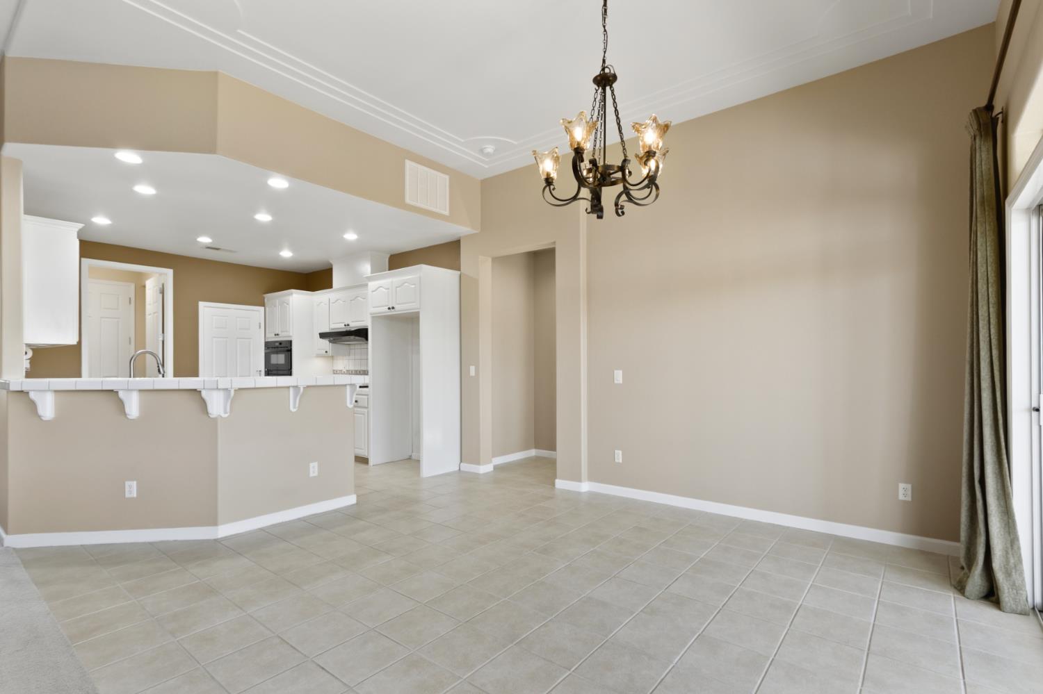 702 Shakeley Lane Ione, CA 95640 - Photo 24 of 71 a view of a kitchen with a refrigerator and a chandelier