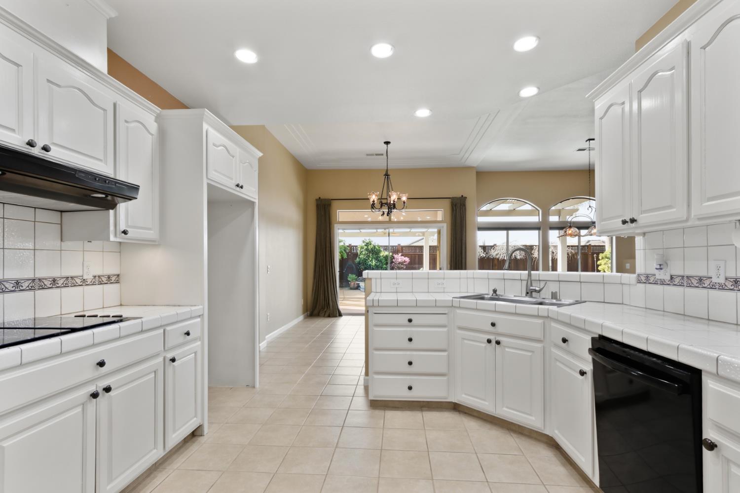 702 Shakeley Lane Ione, CA 95640 - Photo 32 of 71 a kitchen with white cabinets and appliances