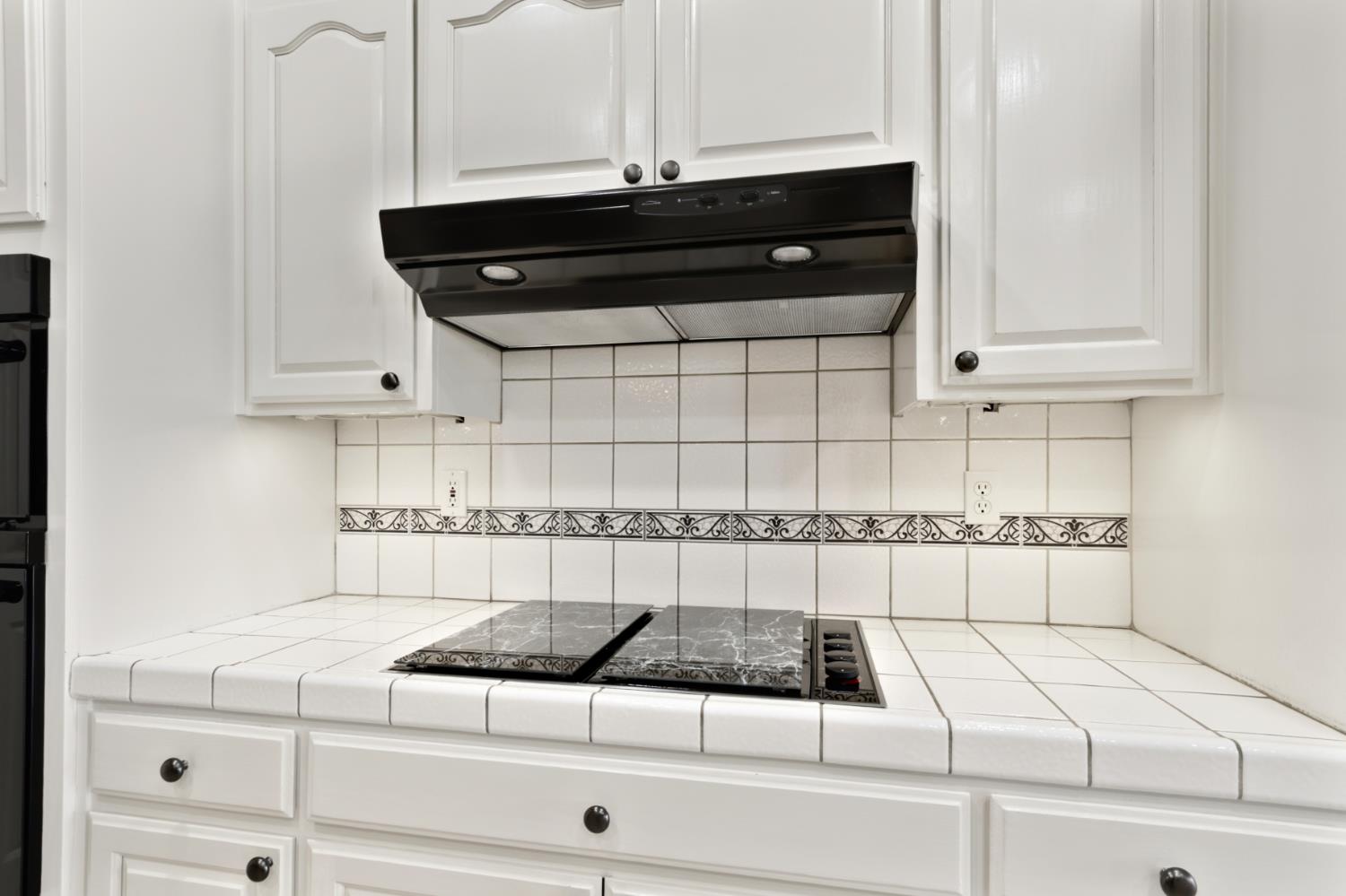 702 Shakeley Lane Ione, CA 95640 - Photo 35 of 71 a kitchen with a stove and white cabinets