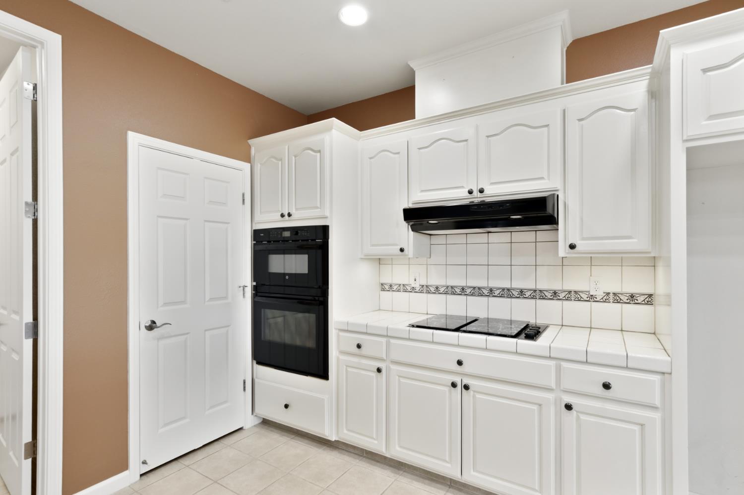 702 Shakeley Lane Ione, CA 95640 - Photo 36 of 71 a kitchen with white cabinets and white appliances