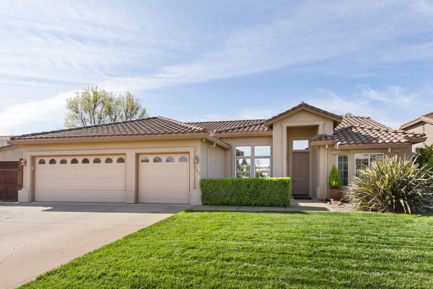 702 Shakeley Lane Ione, CA 95640 - Photo 4 of 71 a front view of a house with a yard and garage