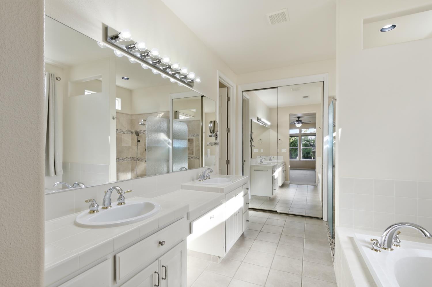 702 Shakeley Lane Ione, CA 95640 - Photo 41 of 71 a spacious bathroom with a bathtub shower sink and mirror