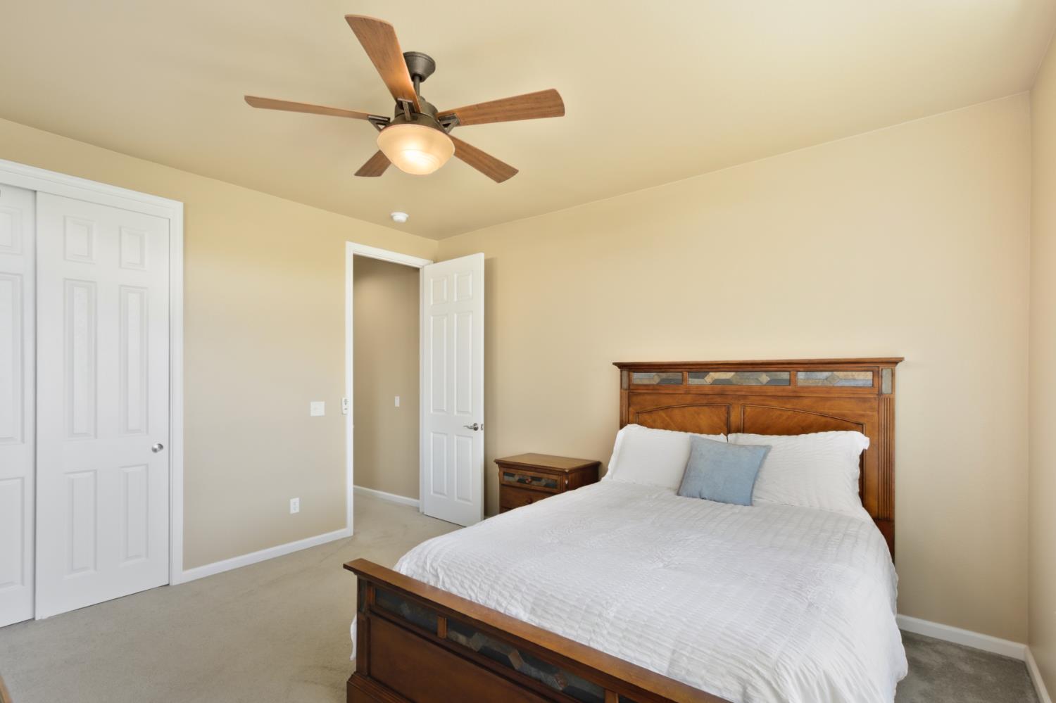 702 Shakeley Lane Ione, CA 95640 - Photo 47 of 71 a bedroom with a bed and a ceiling fan