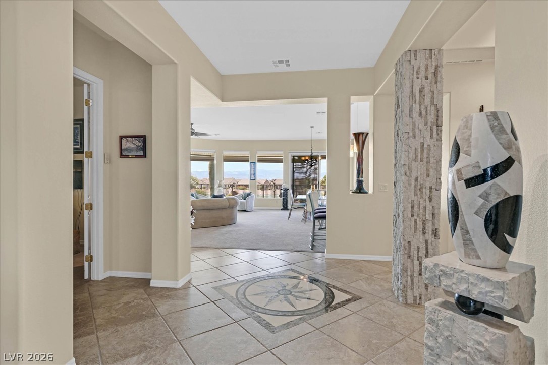 1823 Baton Rouge Street Henderson, NV 89052 - Photo 7 of 60 Tiled flooring and a stone-accented pillar frame the welcoming entry of this home.