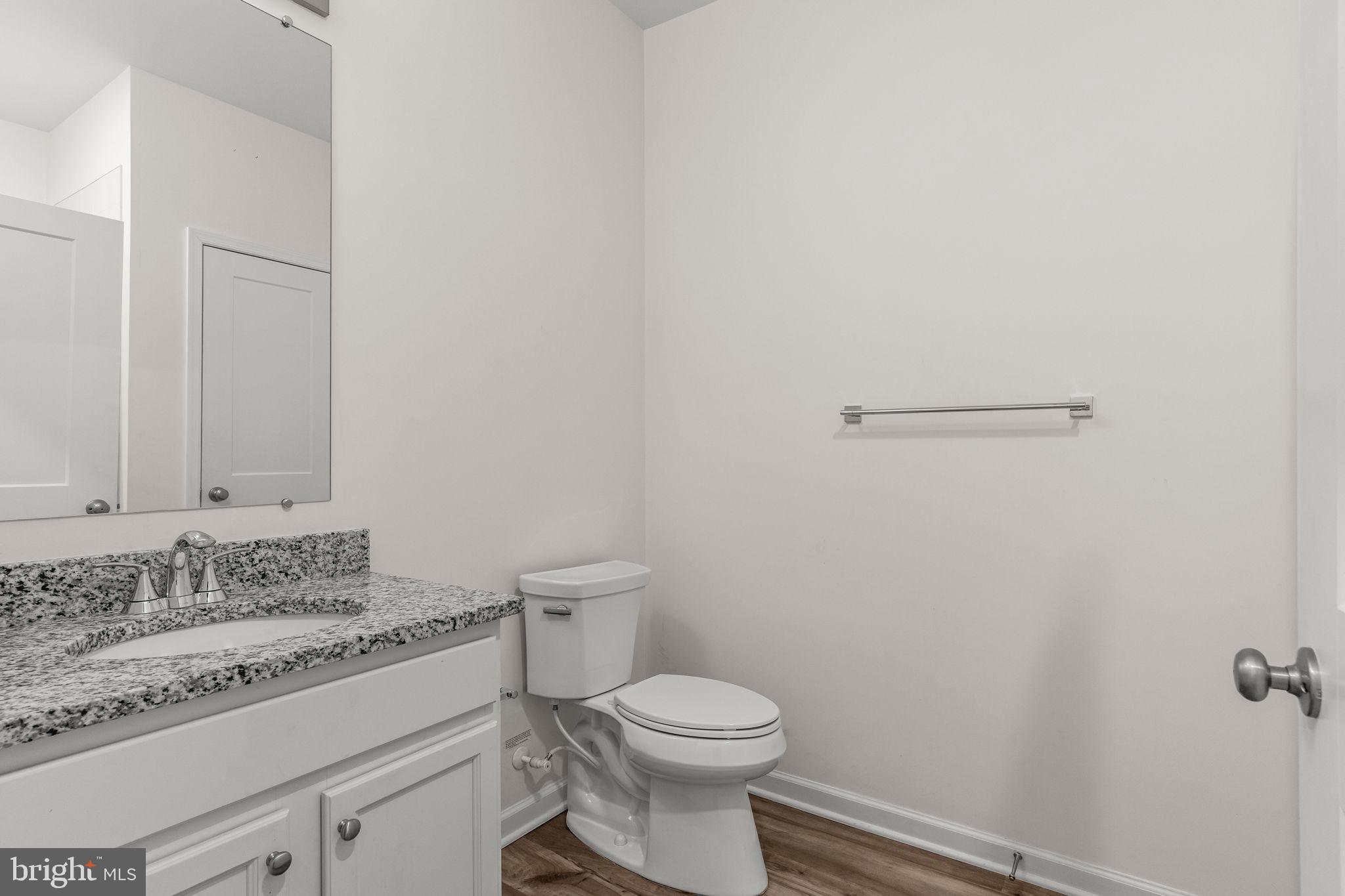 228 Park Lane Dunellen, NJ 08812 - Photo 16 of 35 a bathroom with a granite countertop toilet and a sink