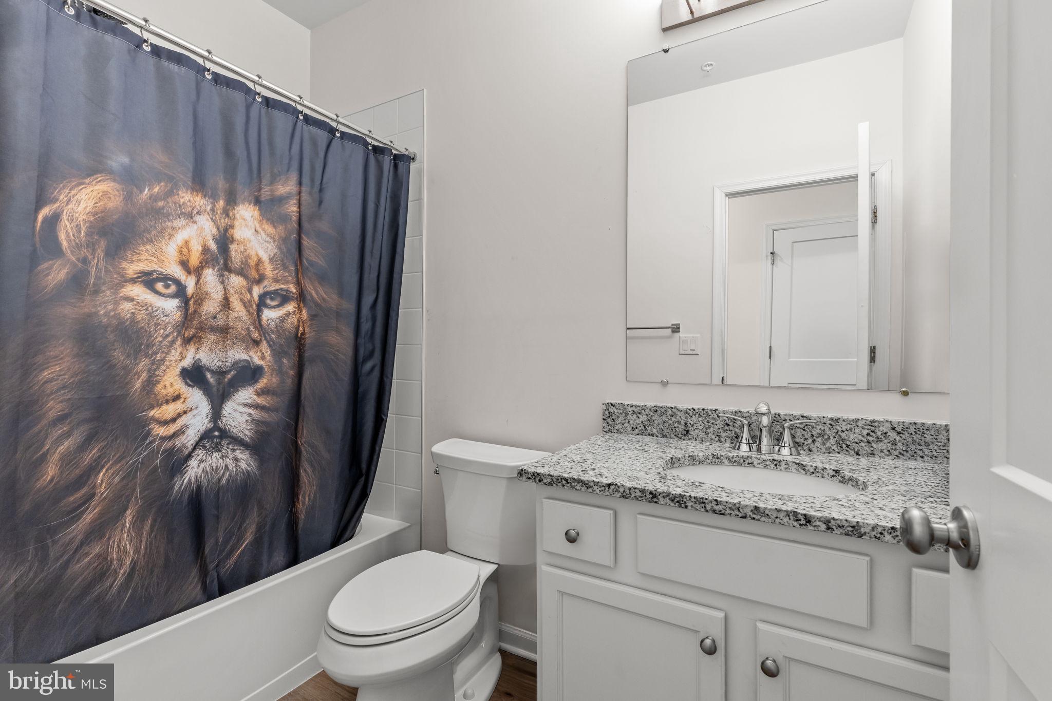 228 Park Lane Dunellen, NJ 08812 - Photo 18 of 35 a bathroom with a granite countertop sink a toilet and a shower curtain