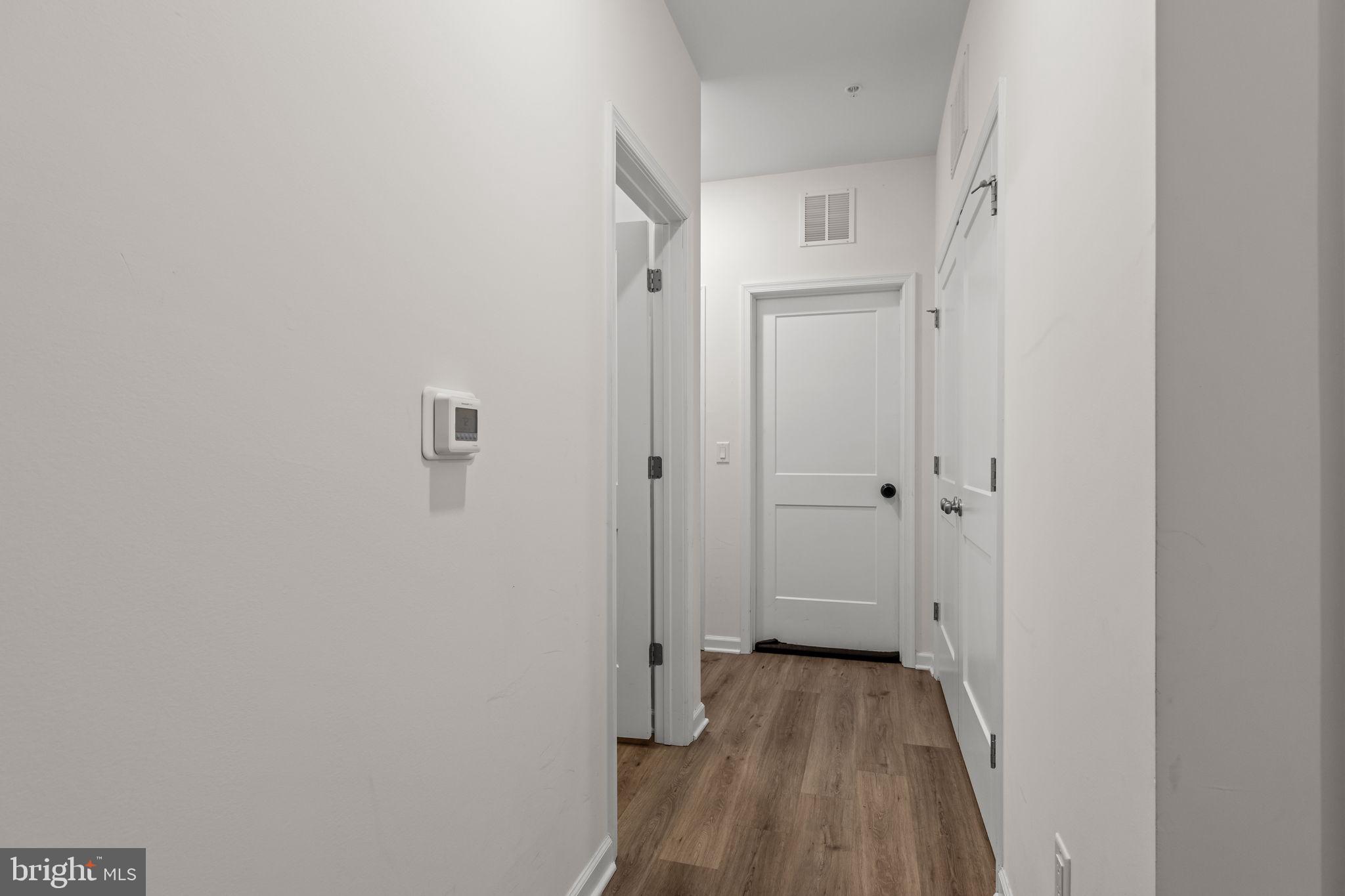 228 Park Lane Dunellen, NJ 08812 - Photo 20 of 35 a view of a hallway with wooden floor and a bathroom