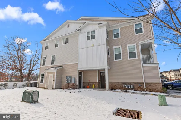a large white building with a yard in front of it