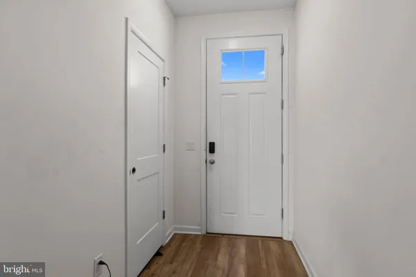 a view of a hallway with wooden floor