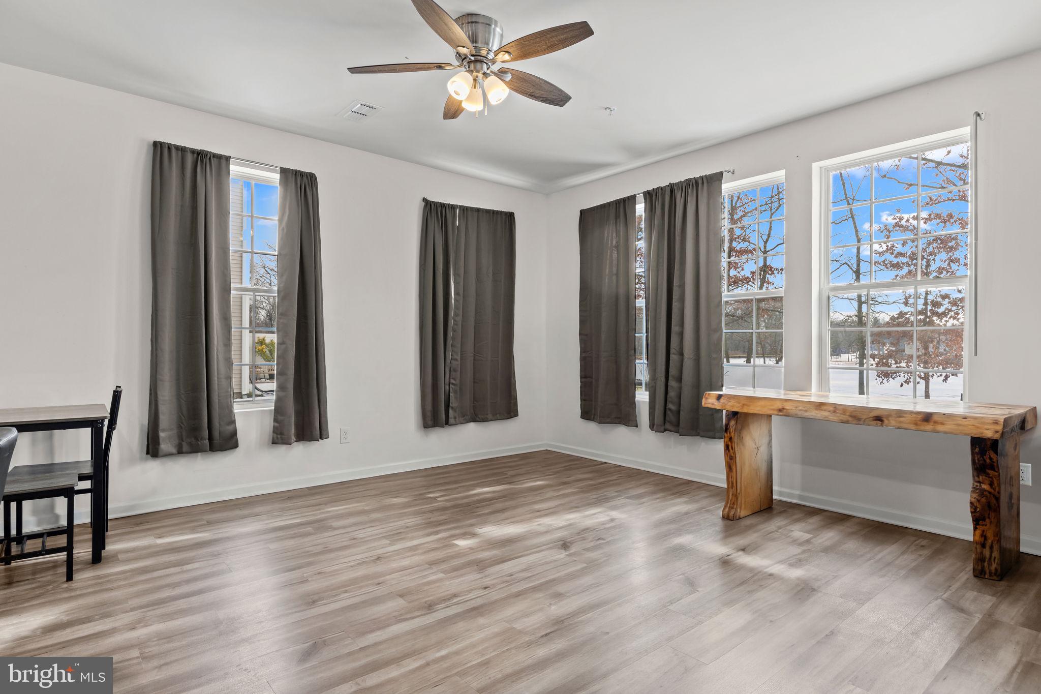 228 Park Lane Dunellen, NJ 08812 - Photo 9 of 35 a view of an empty room with window and wooden floor