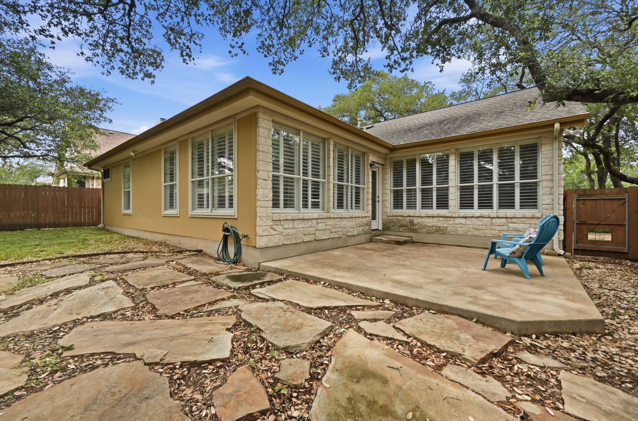5313 Moon Shadow Drive Austin, TX 78735 - Photo 28 of 30 Exterior featuring a stone and stucco facade, a concrete patio, and a flagstone pathway