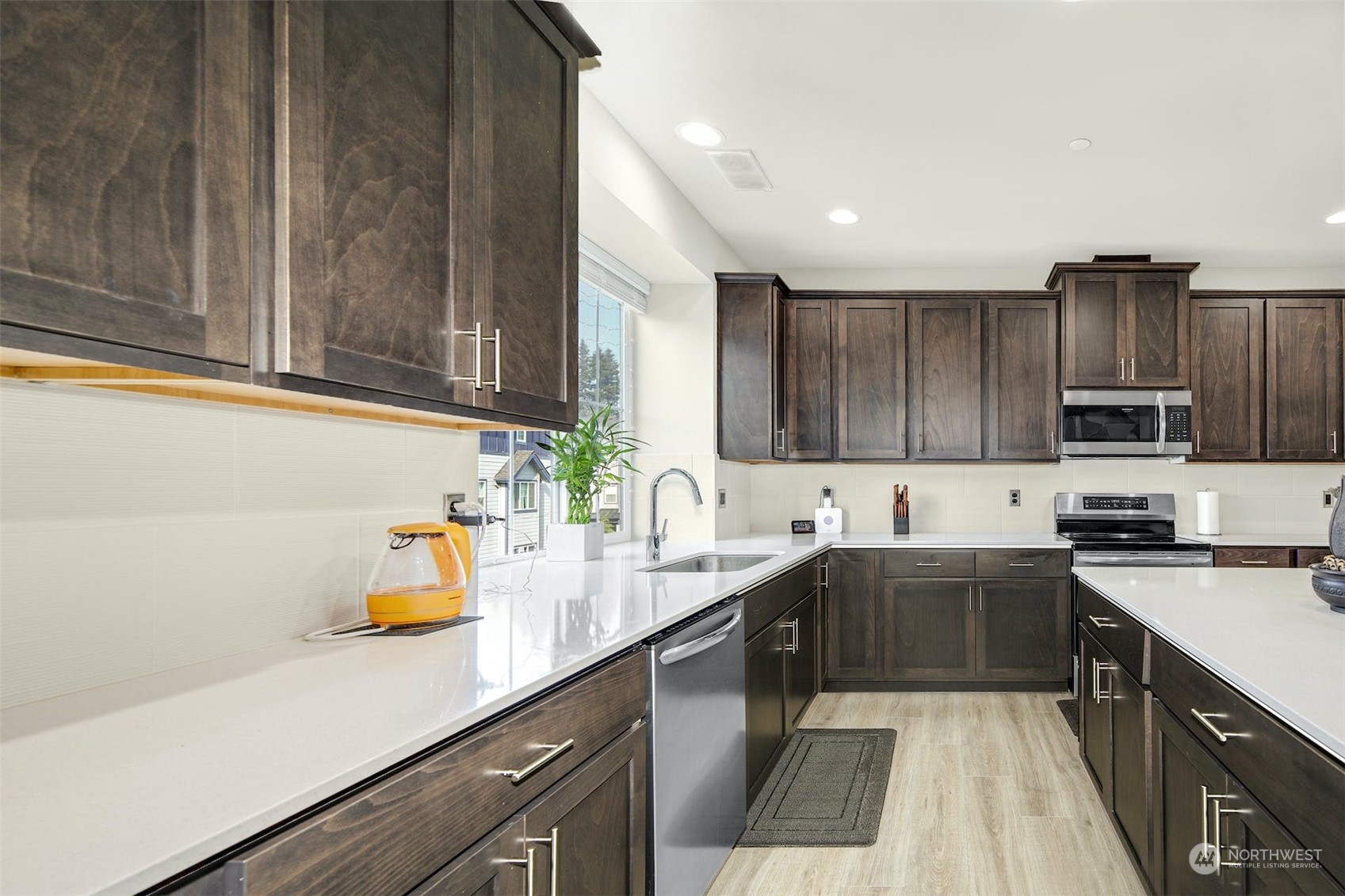 1621 Seattle Hill Road, Unit A1 Bothell, WA 98012 - Photo 11 of 28 a kitchen with stainless steel appliances granite countertop a sink stove and cabinets