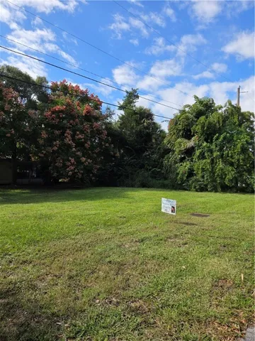 a view of a field of grass and trees
