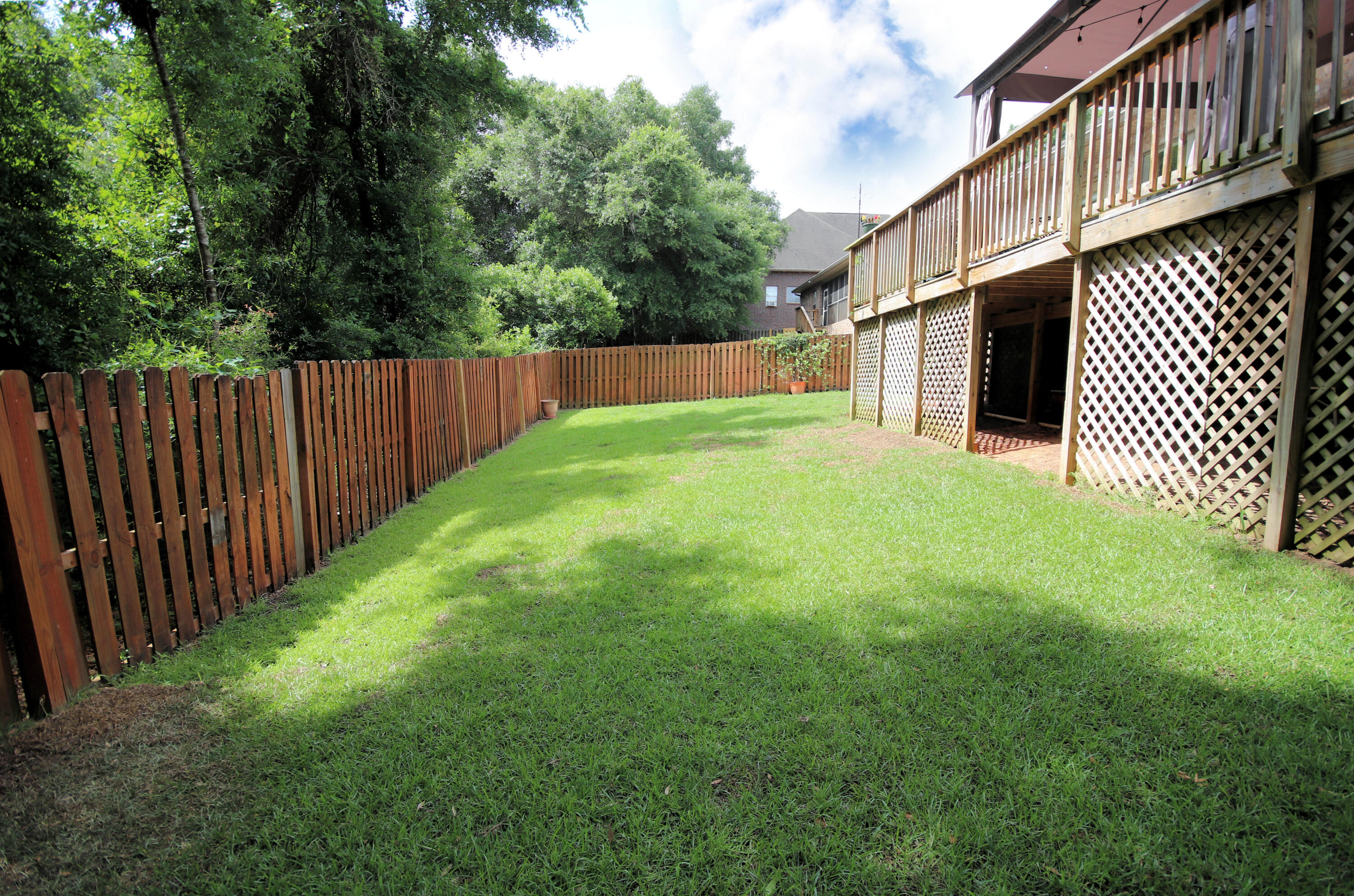 614 Red Fern Road Crestview, FL 32536 - Photo 42 of 43 a backyard of a house with lots of green space