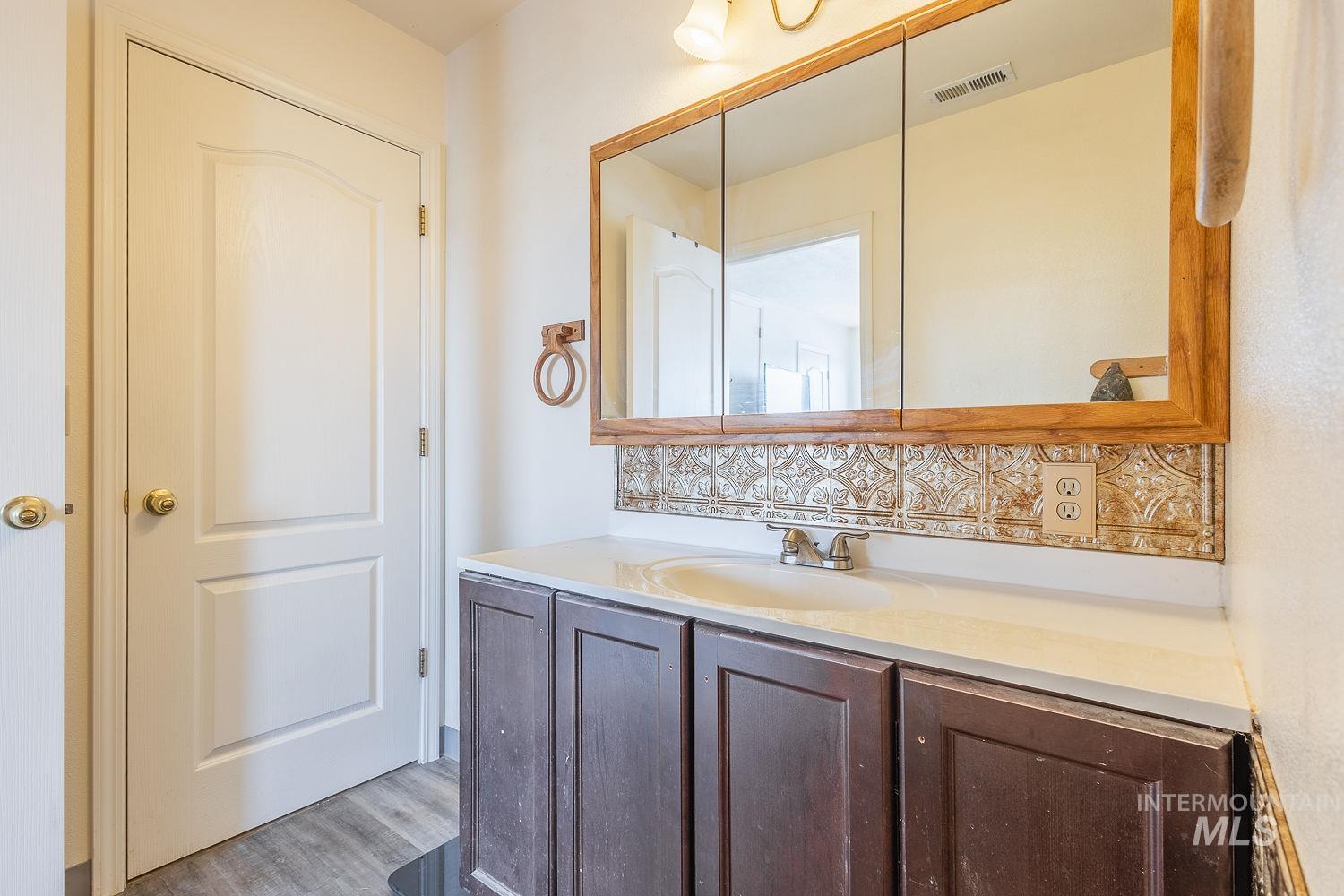 6050 Elmore Road Fruitland, ID 83619 - Photo 18 of 48 Bathroom with vanity and light wood-style floors
