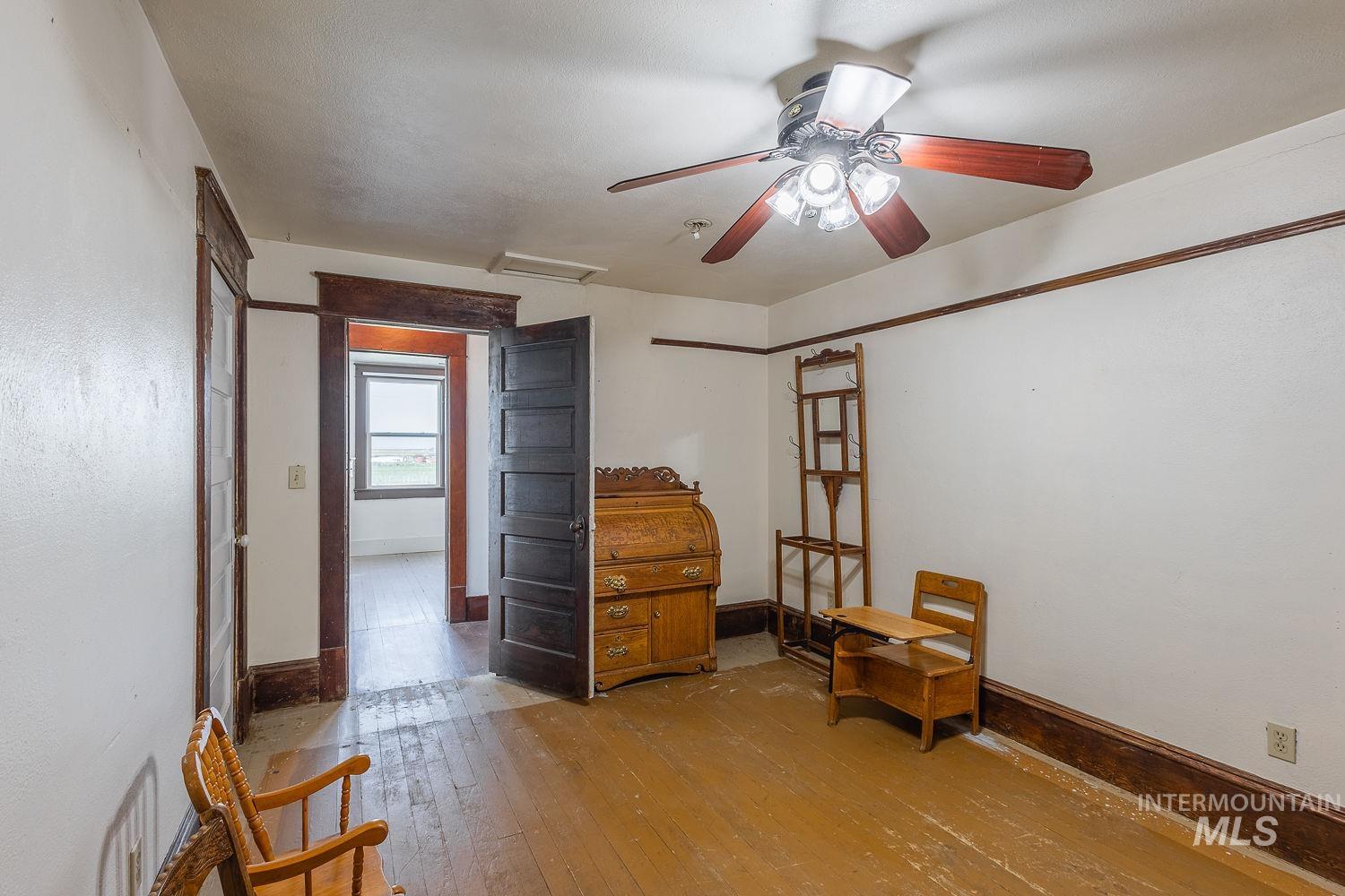 6050 Elmore Road Fruitland, ID 83619 - Photo 20 of 48 Sitting room with attic access, hardwood / wood-style floors, and a ceiling fan