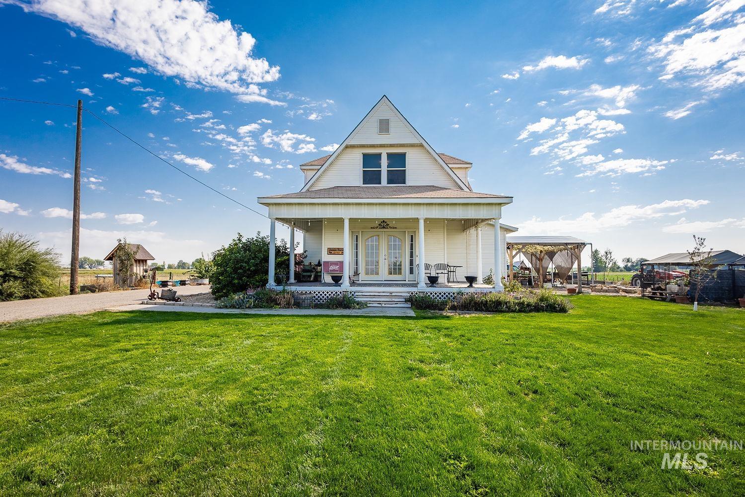 6050 Elmore Road Fruitland, ID 83619 - Photo 2 of 48 View of front of home featuring covered porch and a front yard