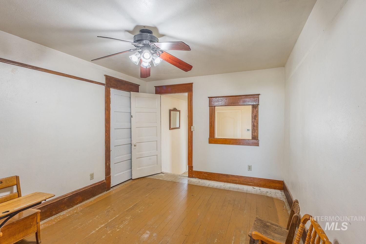 6050 Elmore Road Fruitland, ID 83619 - Photo 22 of 48 Unfurnished bedroom featuring hardwood / wood-style floors and ceiling fan