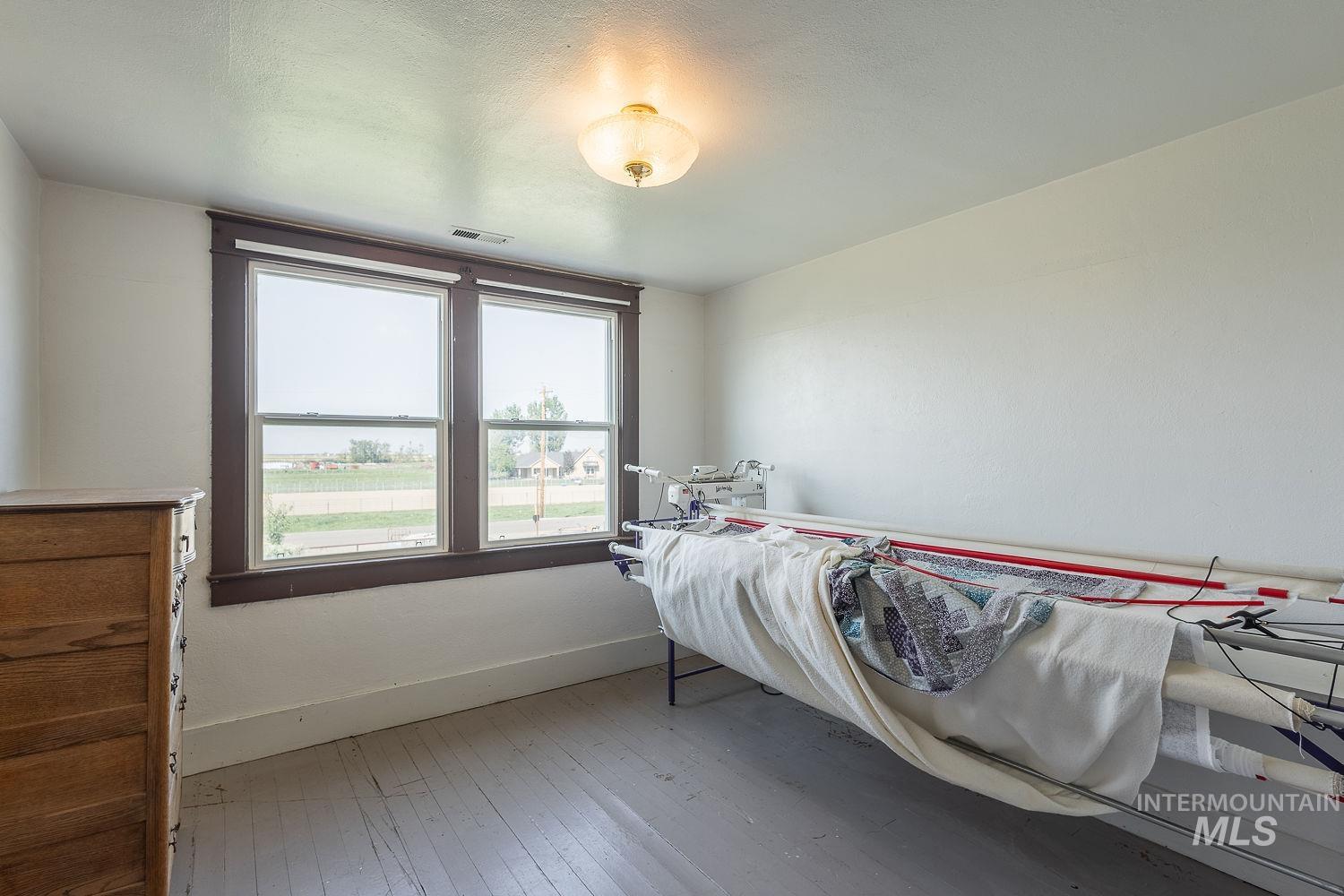 6050 Elmore Road Fruitland, ID 83619 - Photo 23 of 48 Bedroom with baseboards and light wood-style floors