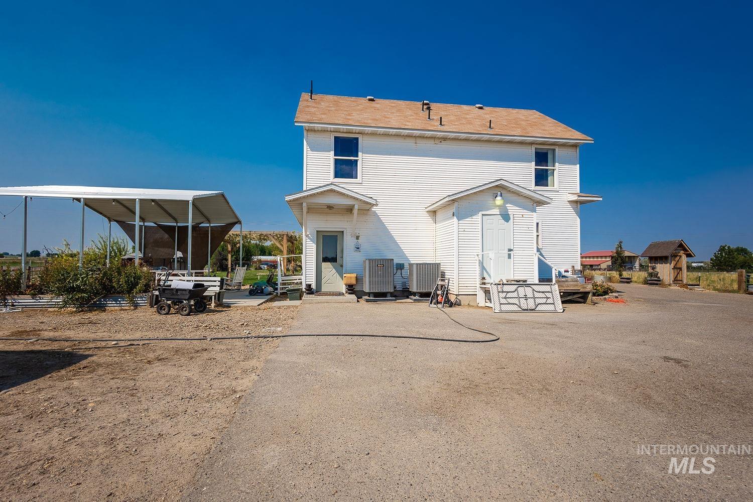 6050 Elmore Road Fruitland, ID 83619 - Photo 40 of 48 Rear view of house featuring a patio area