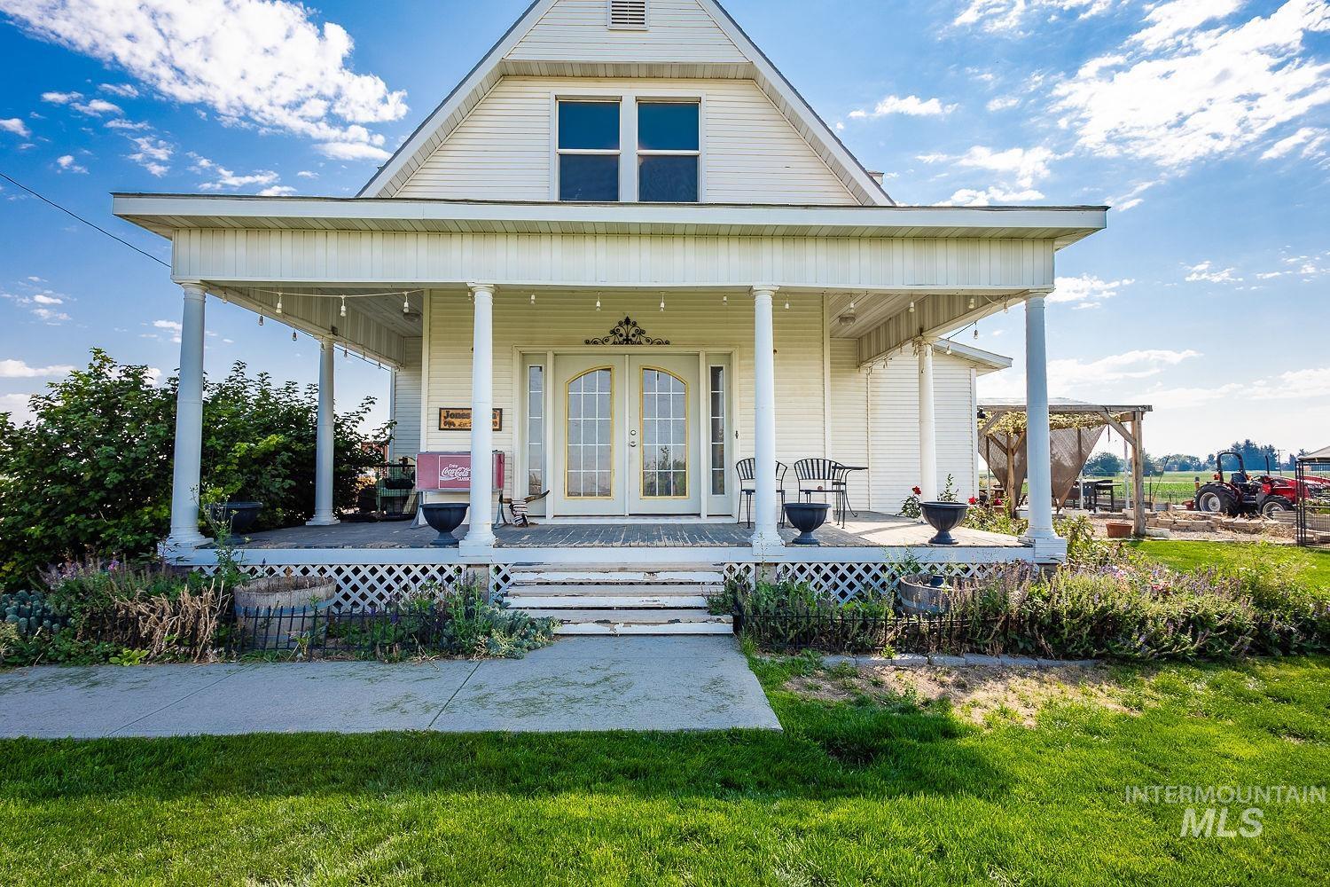 6050 Elmore Road Fruitland, ID 83619 - Photo 4 of 48 View of exterior entry featuring covered porch, french doors, and a lawn