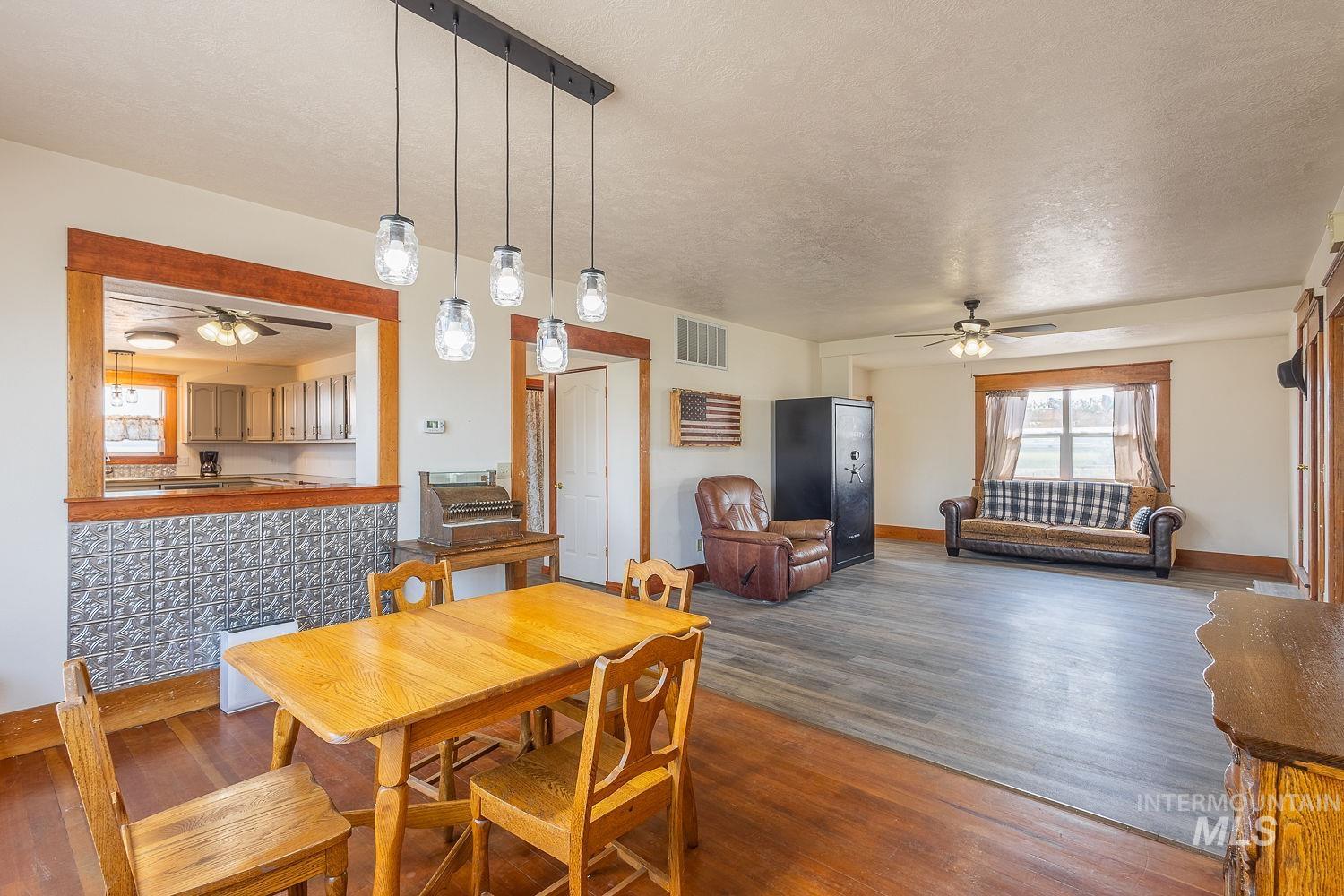 6050 Elmore Road Fruitland, ID 83619 - Photo 8 of 48 Dining area with ceiling fan, dark wood finished floors, and a textured ceiling
