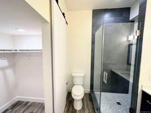 a bathroom with a toilet and a shower